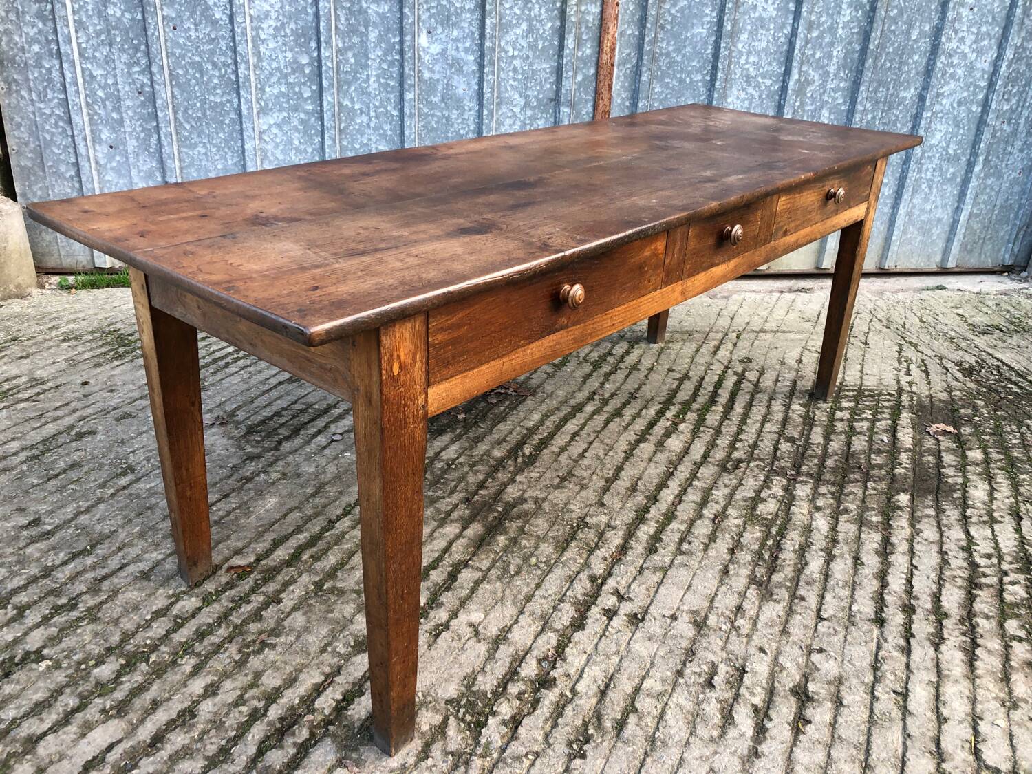 Antique chestnut farmhouse table with 3 drawers on the front.