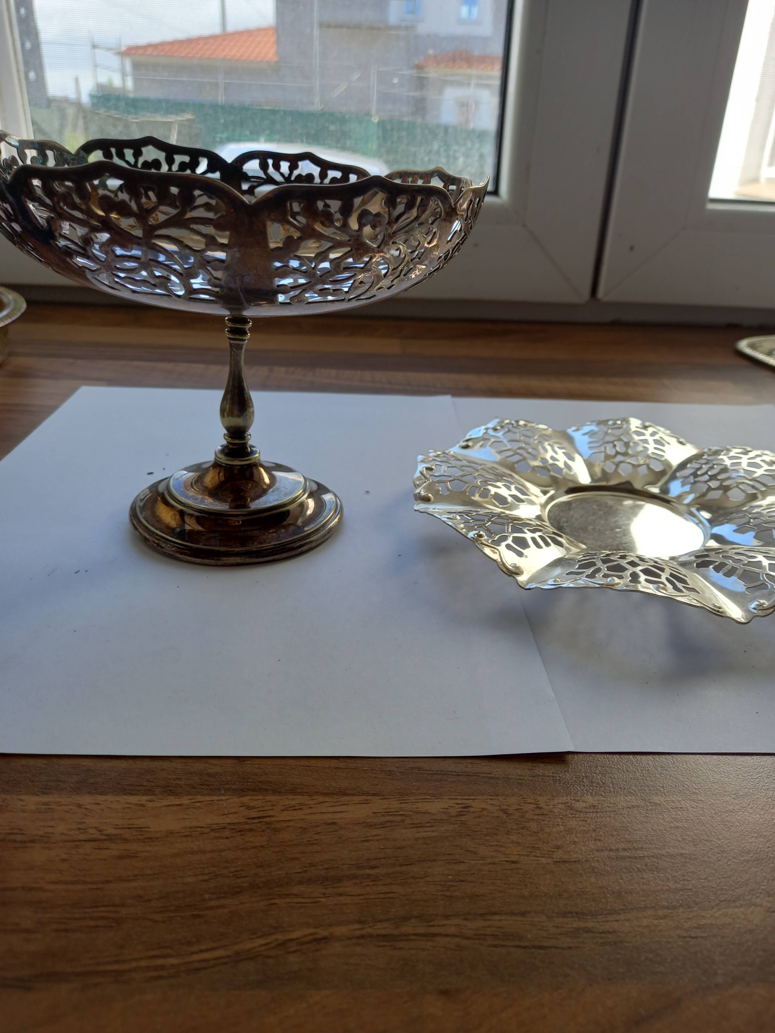 Two metal cups with an openwork design.