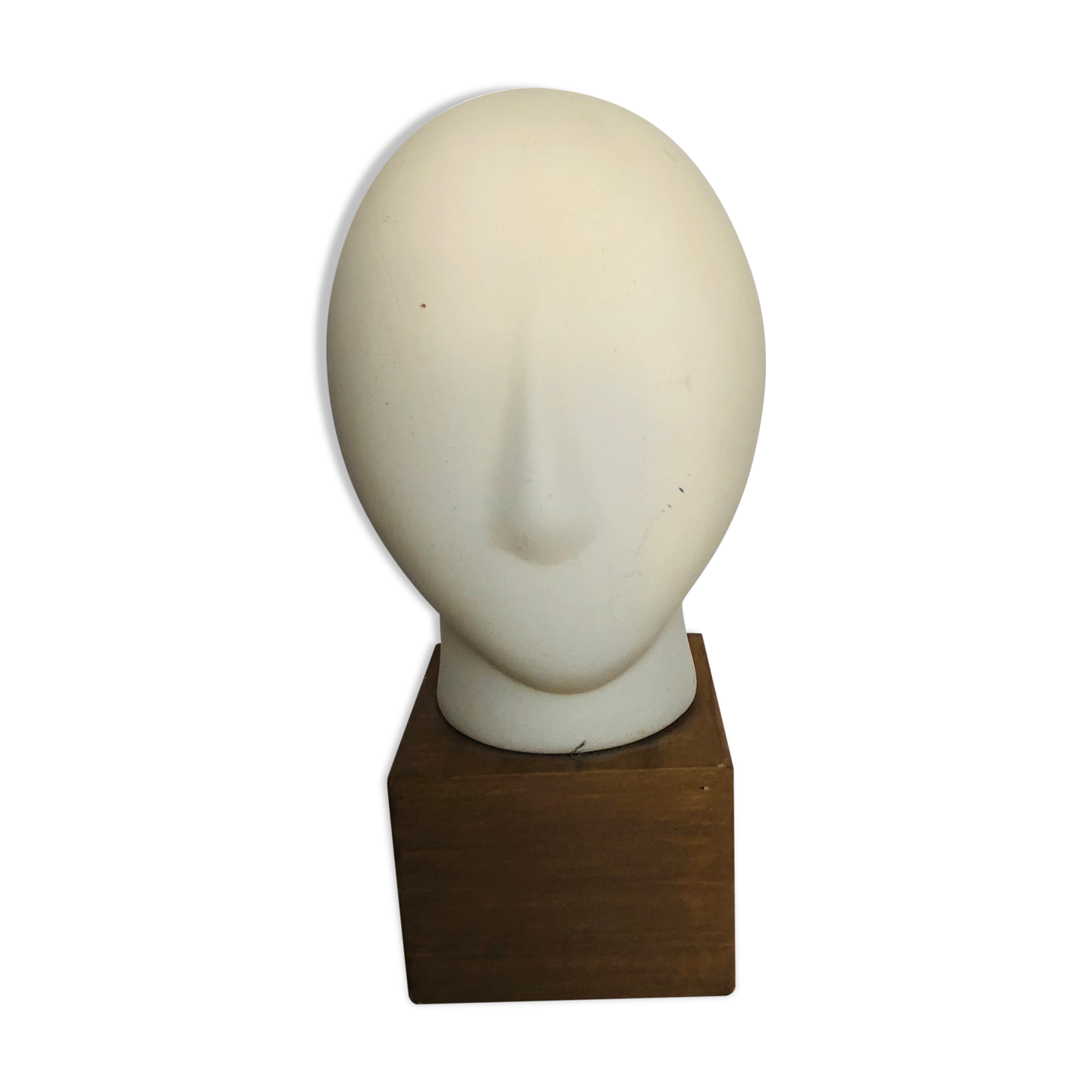 Ceramic head on wooden base