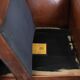 Sheepskin wingback armchair finished with black piping and a correct seat