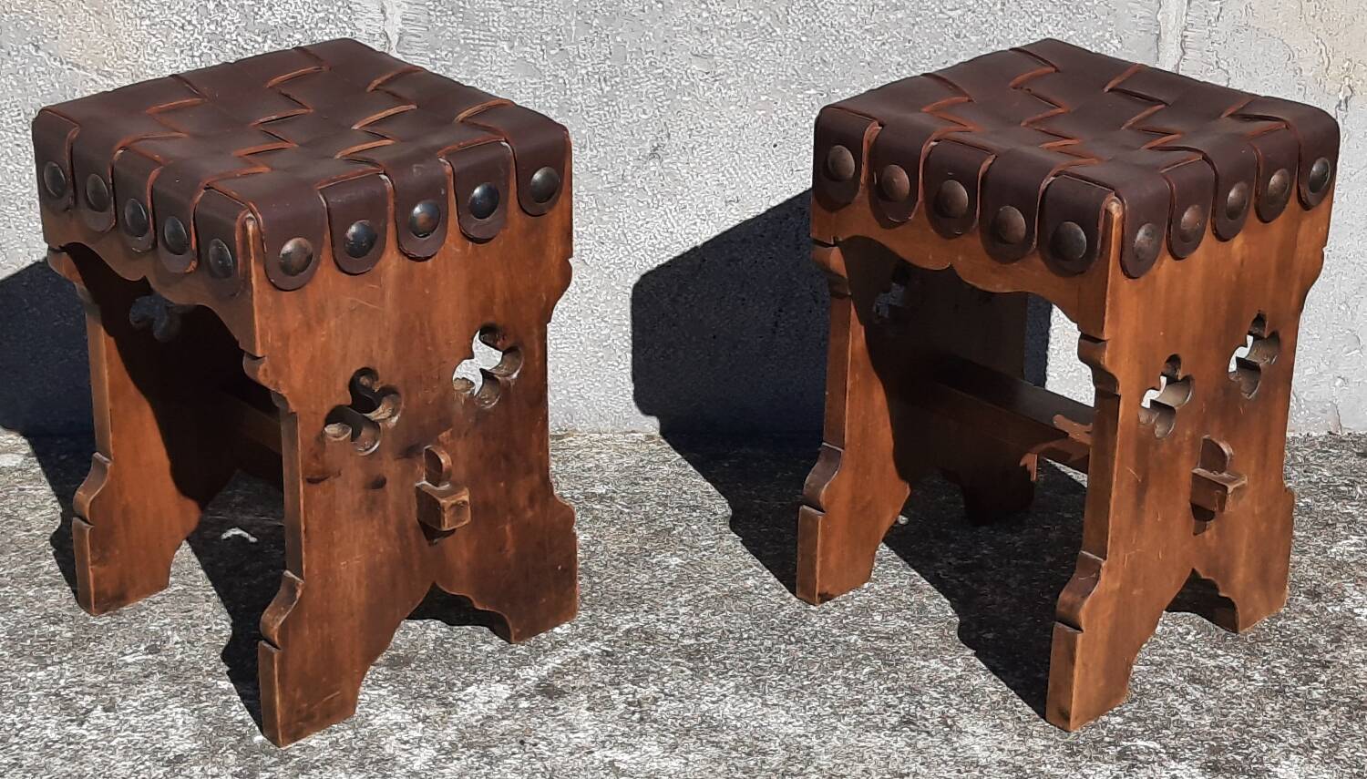 Pair of brutalist stools, leather seat.