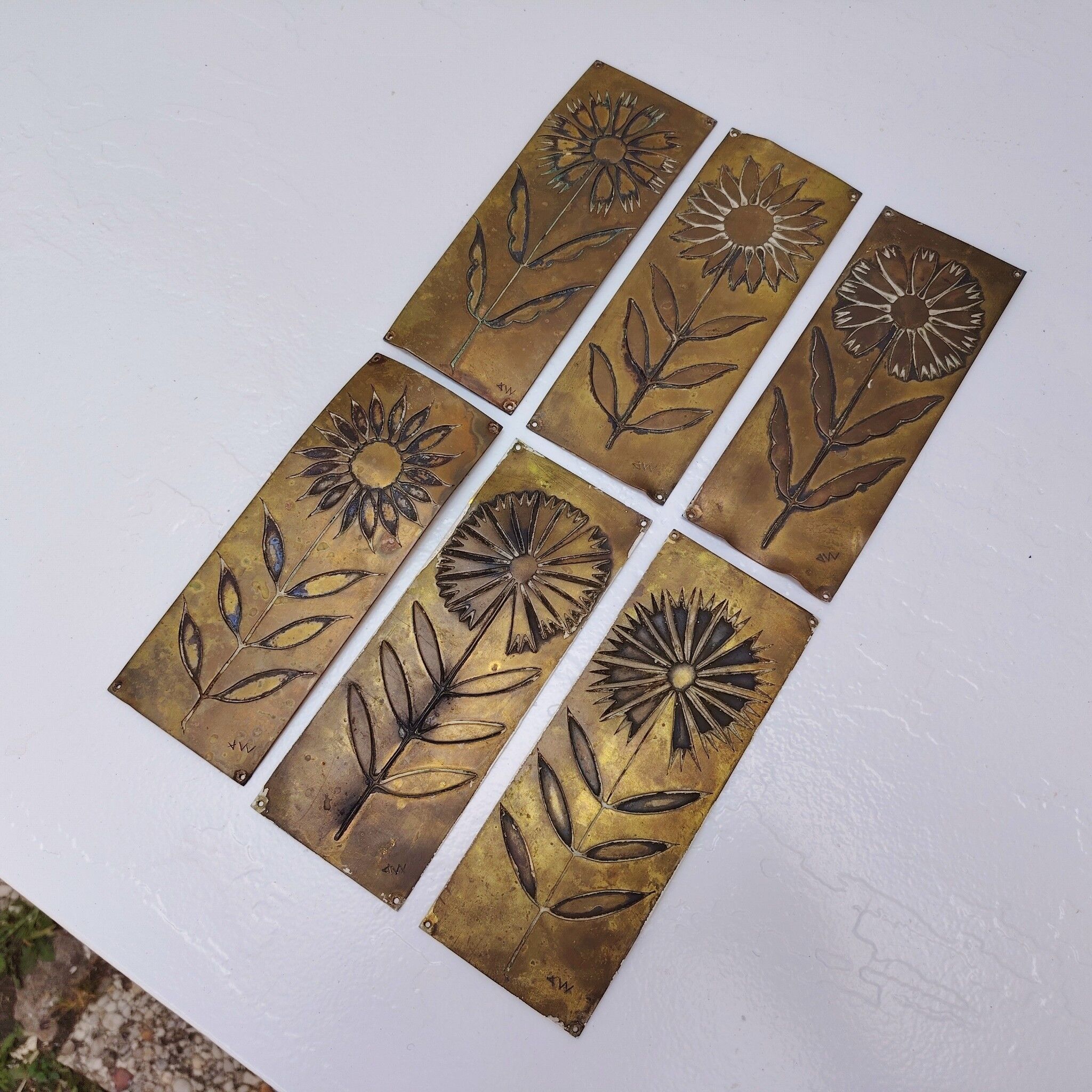 Six cleanliness plaques, flower design, brass.