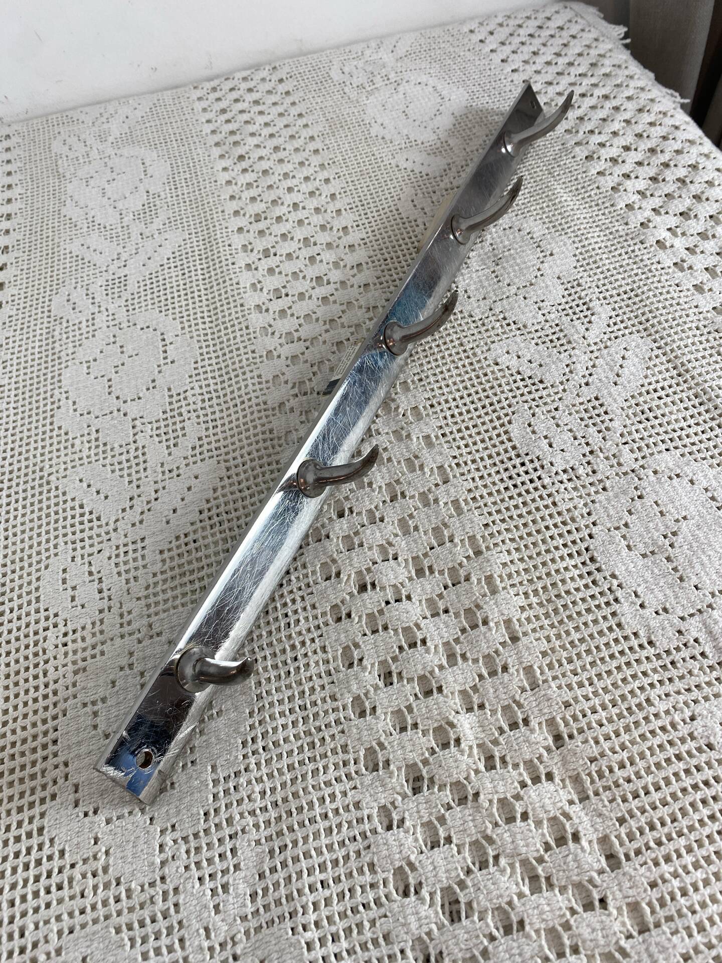 Stainless steel butcher's hook, known as a "wolf tooth bar."