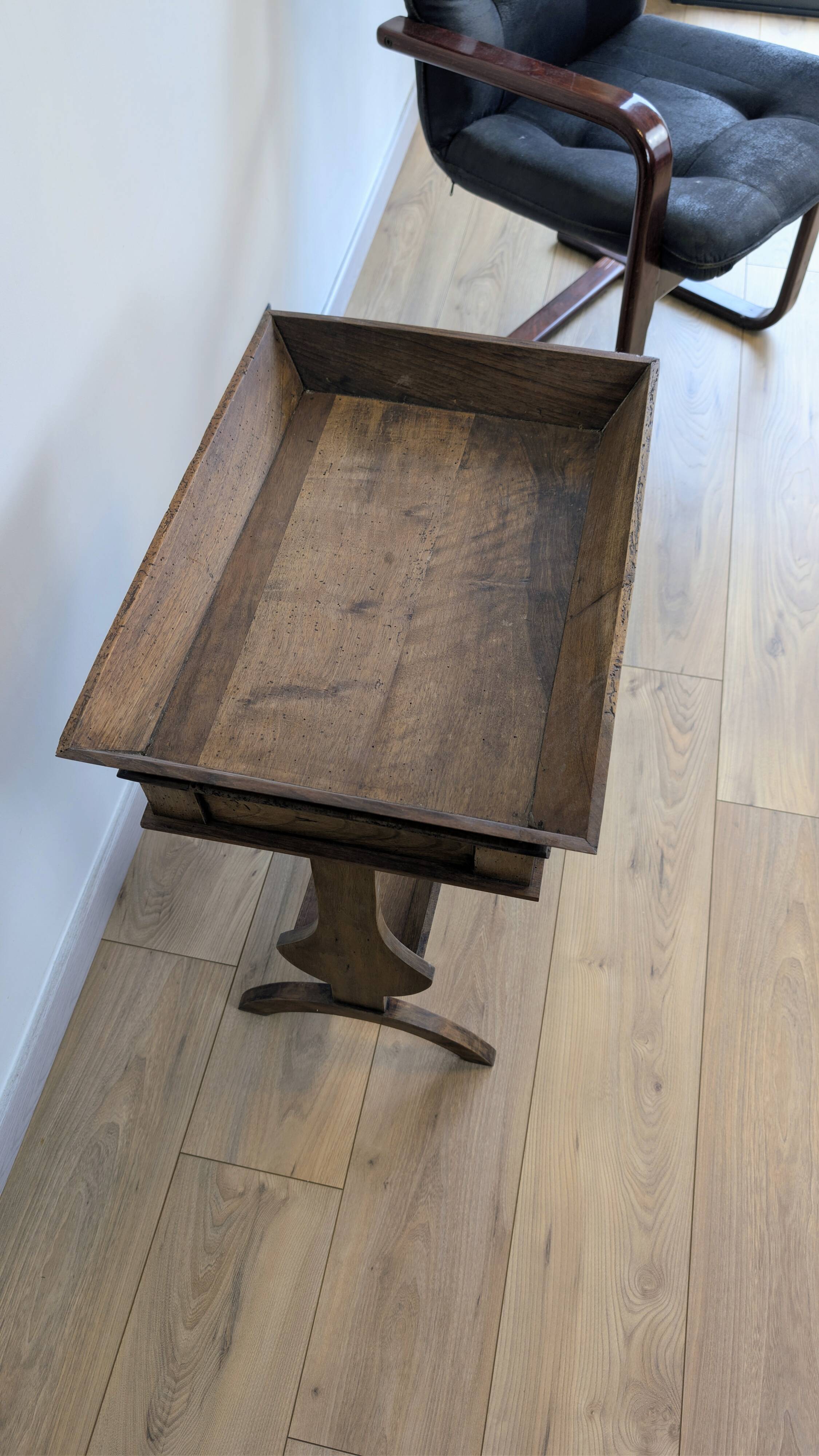 Old wooden pocket emptying table with drawer and planter.