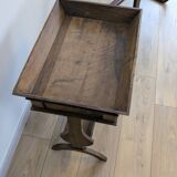 Old wooden pocket emptying table with drawer and planter.