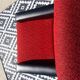 Vintage armchairs in red and black faux leather, the pair.