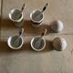 Set of 4 egg cups with their spoons, salt shaker, colored pepper shaker