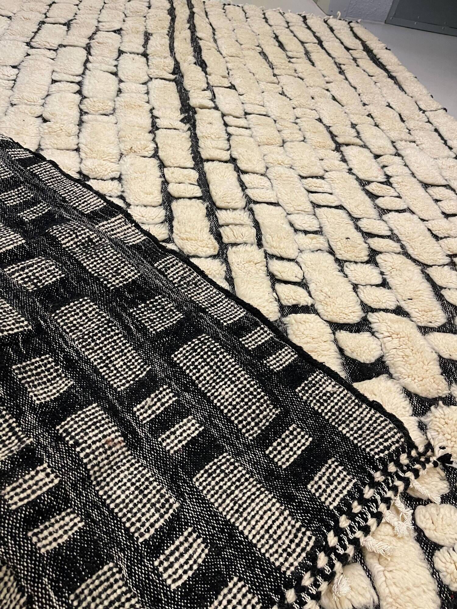 Large cream and black checked Berber rug, 280 × 200 cm.