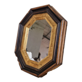 Antique mirror in black and gold octagonal wood