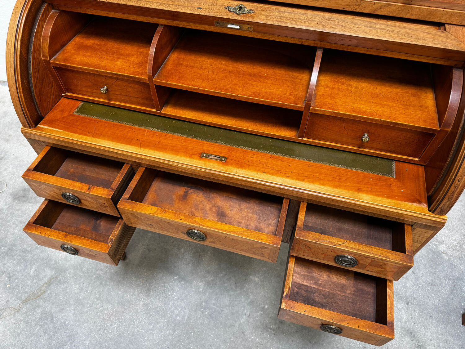 Cylinder desk with marquetry featuring a crosshatch design.