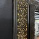 19th-century mirror Napoleon III in blackened wood on a gold background.
