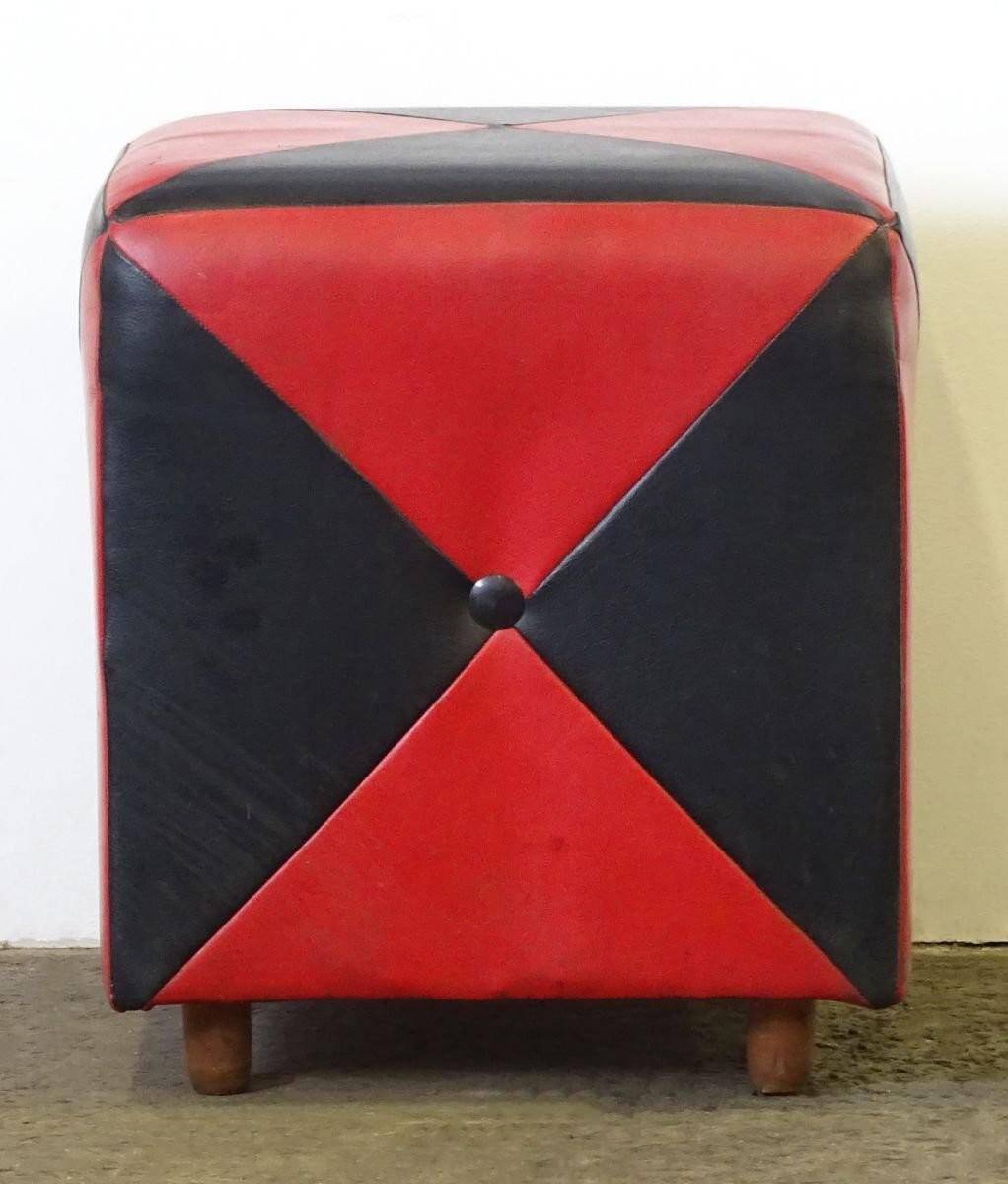 Mid-century ottoman stool in red and black faux leather with wooden legs.