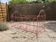 Old iron bed for children, painted pink with scrolls, romantic style.