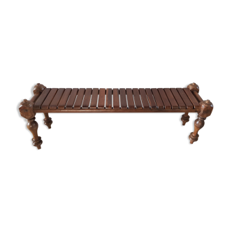 Bench with slats and feet of charpoy beds in teak