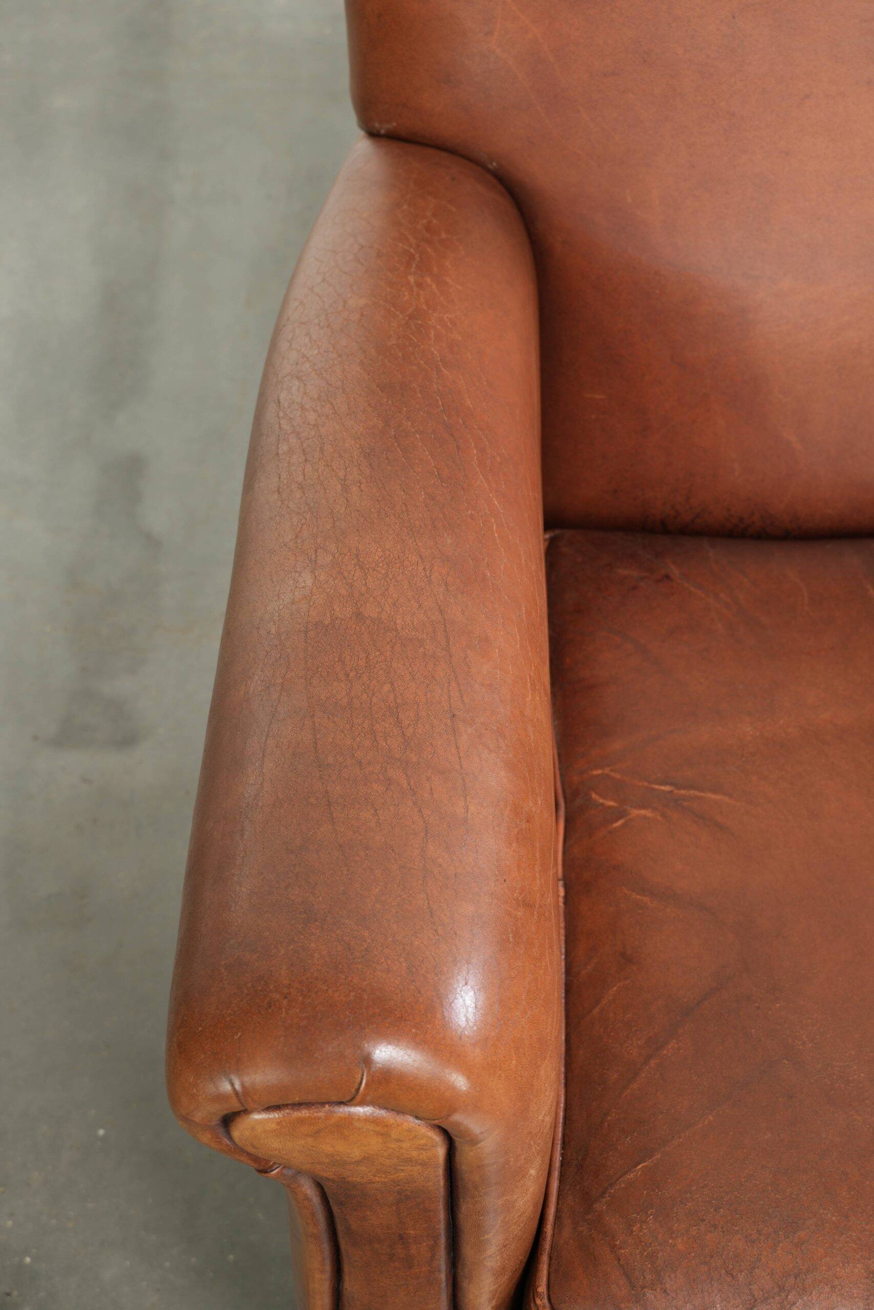 Sturdy vintage sheepskin armchair with a beautiful cognac colour