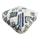 Berber floor pouf: Handwoven Moroccan wool cushion.