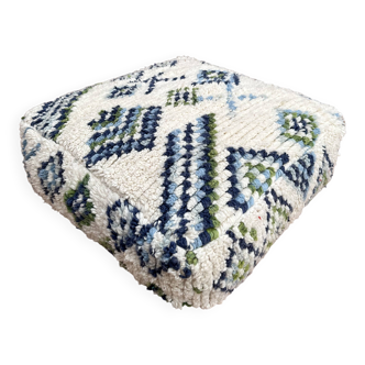 Berber floor pouf: Handwoven Moroccan wool cushion.