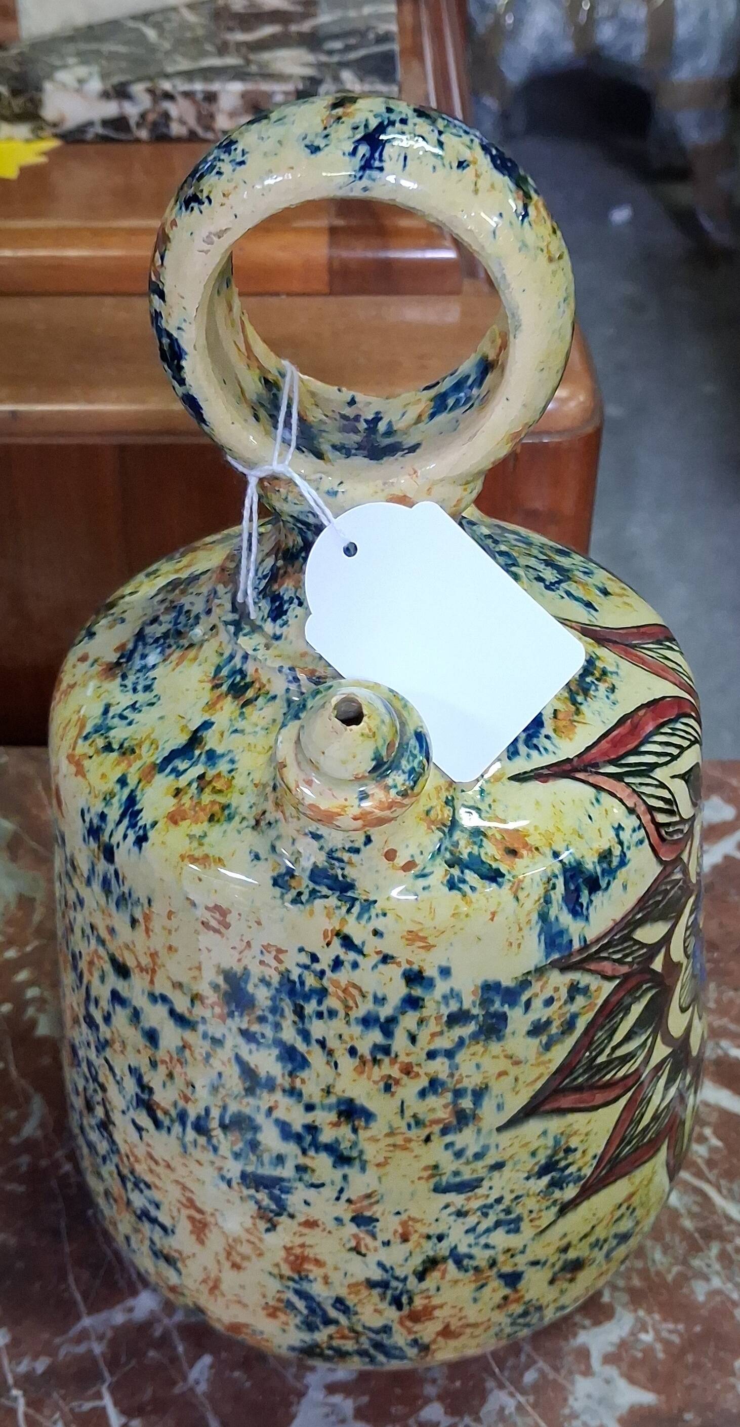 polychrome floral-decorated jug in glazed ceramic