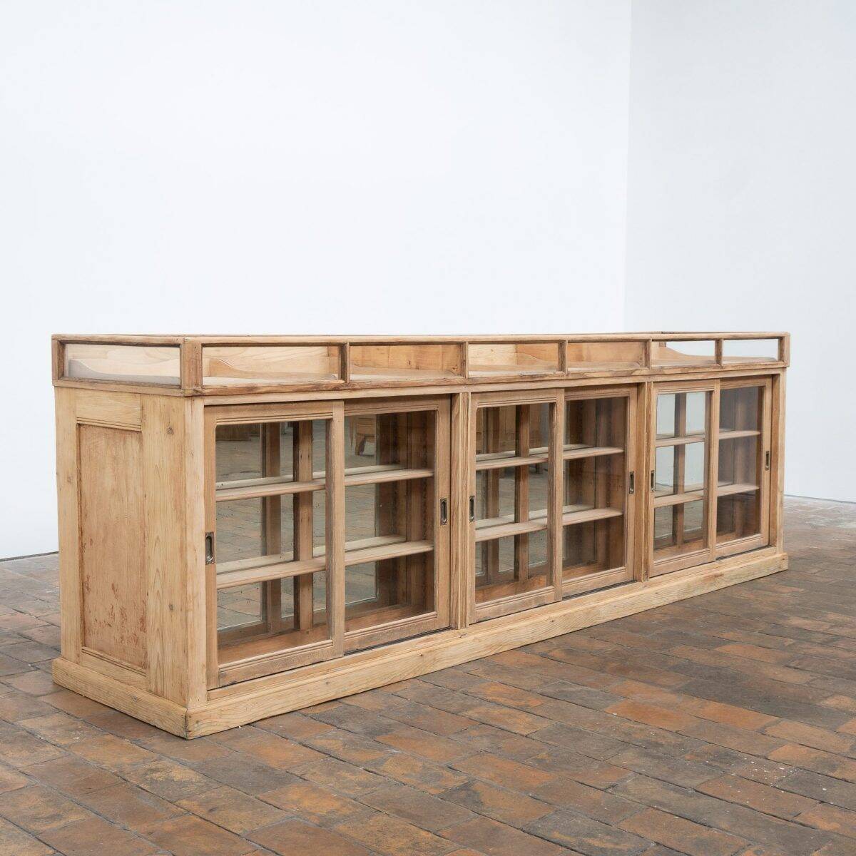 Old glass-fronted pine trade counter - early 20th century