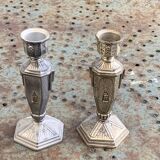 Pair of metal candlesticks, chiseled with a statuette in front, rose pattern in relief, art deco