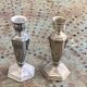 Pair of metal candlesticks, chiseled with a statuette in front, rose pattern in relief, art deco