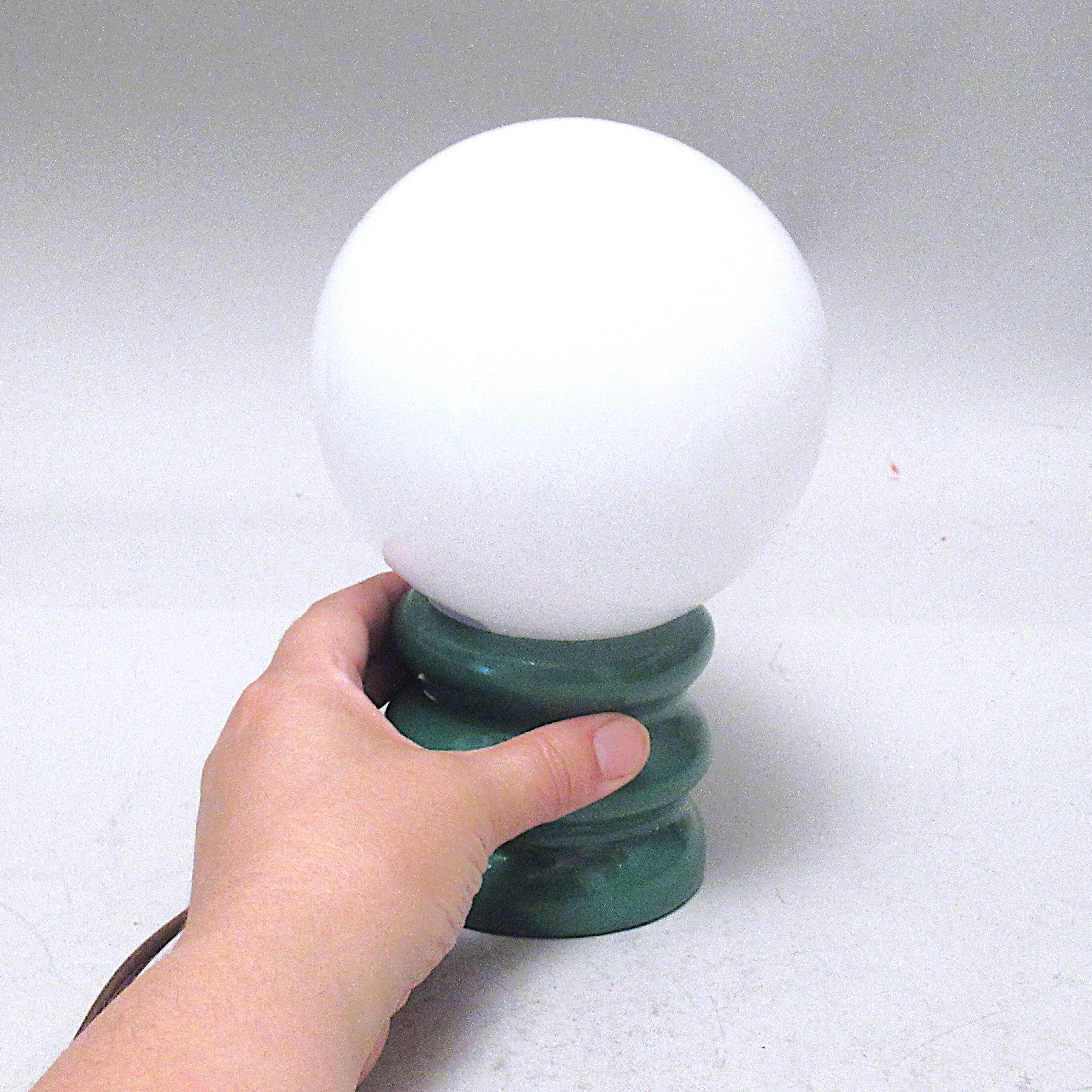 Green 1970s floor lamp with a globe shade.