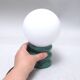 Green 1970s floor lamp with a globe shade.