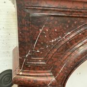 Pair of Louis XIV style fireplaces in red cherry marble. XIX century.