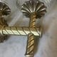 Pair of neoclassical wall sconces in twisted brass and ribbed glass.