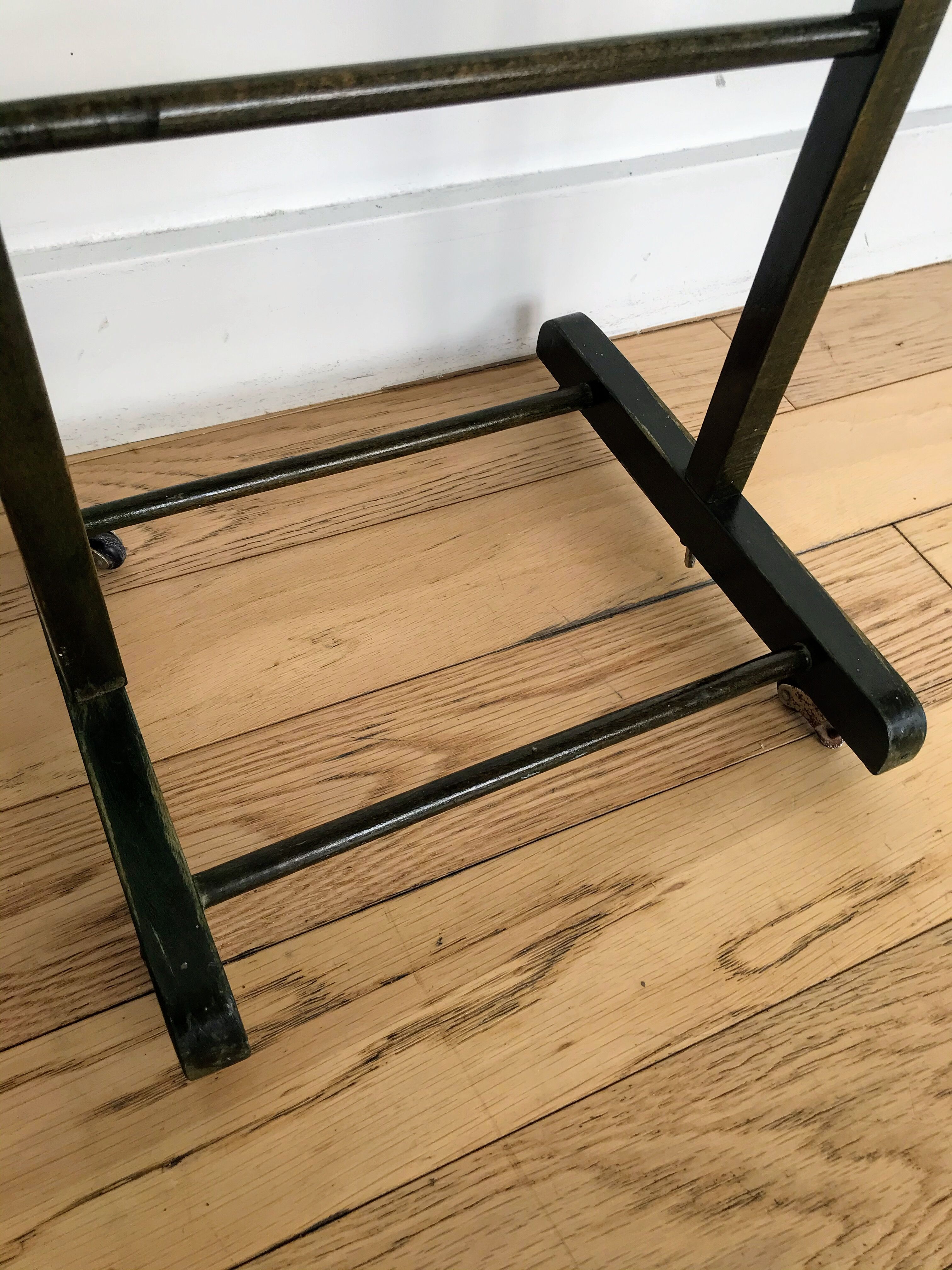 Vintage children's room valet in green varnished wood on roulette