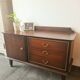 Dark wood sideboard with brass finishes and compass feet