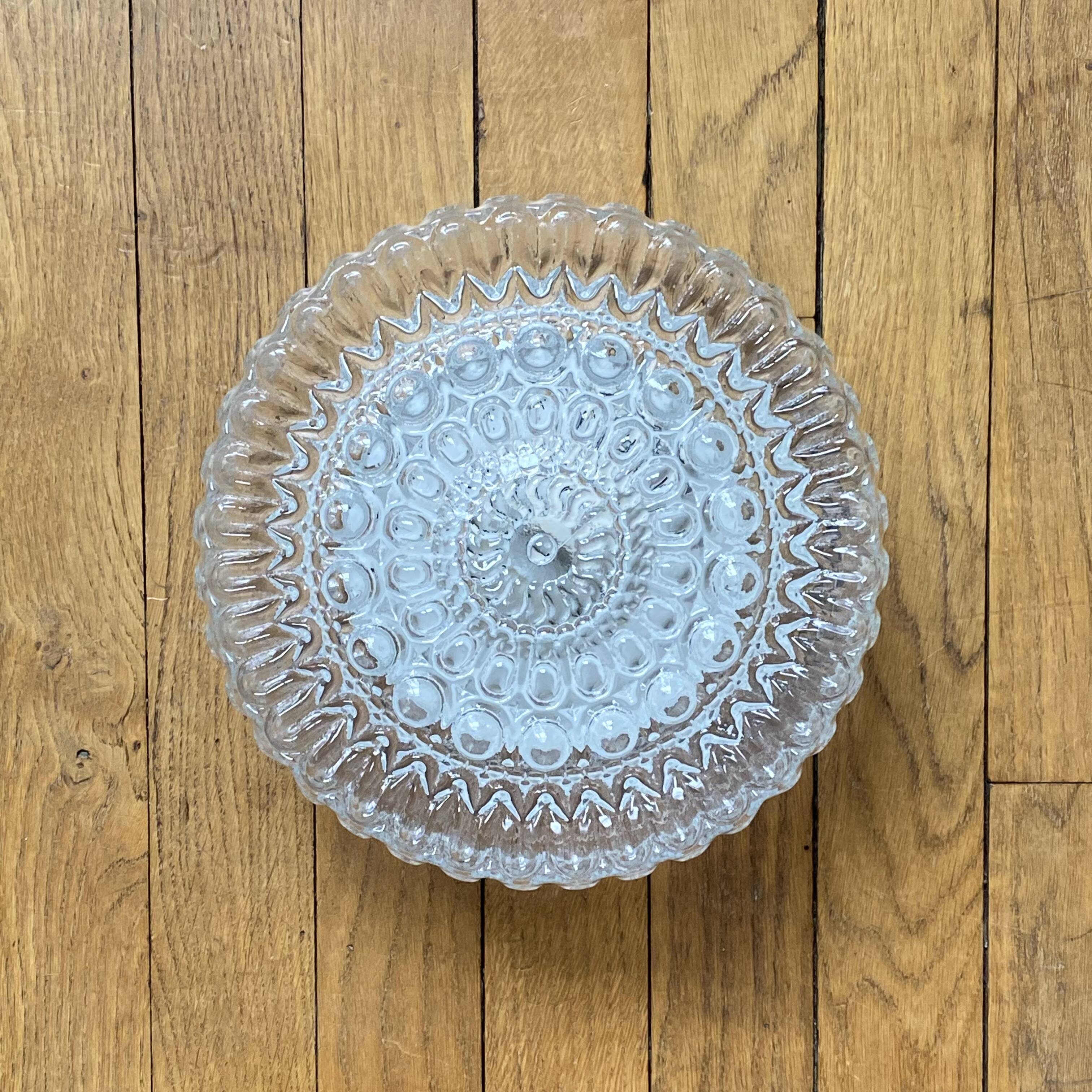 Large wall-mounted ceiling light with transparent glass.