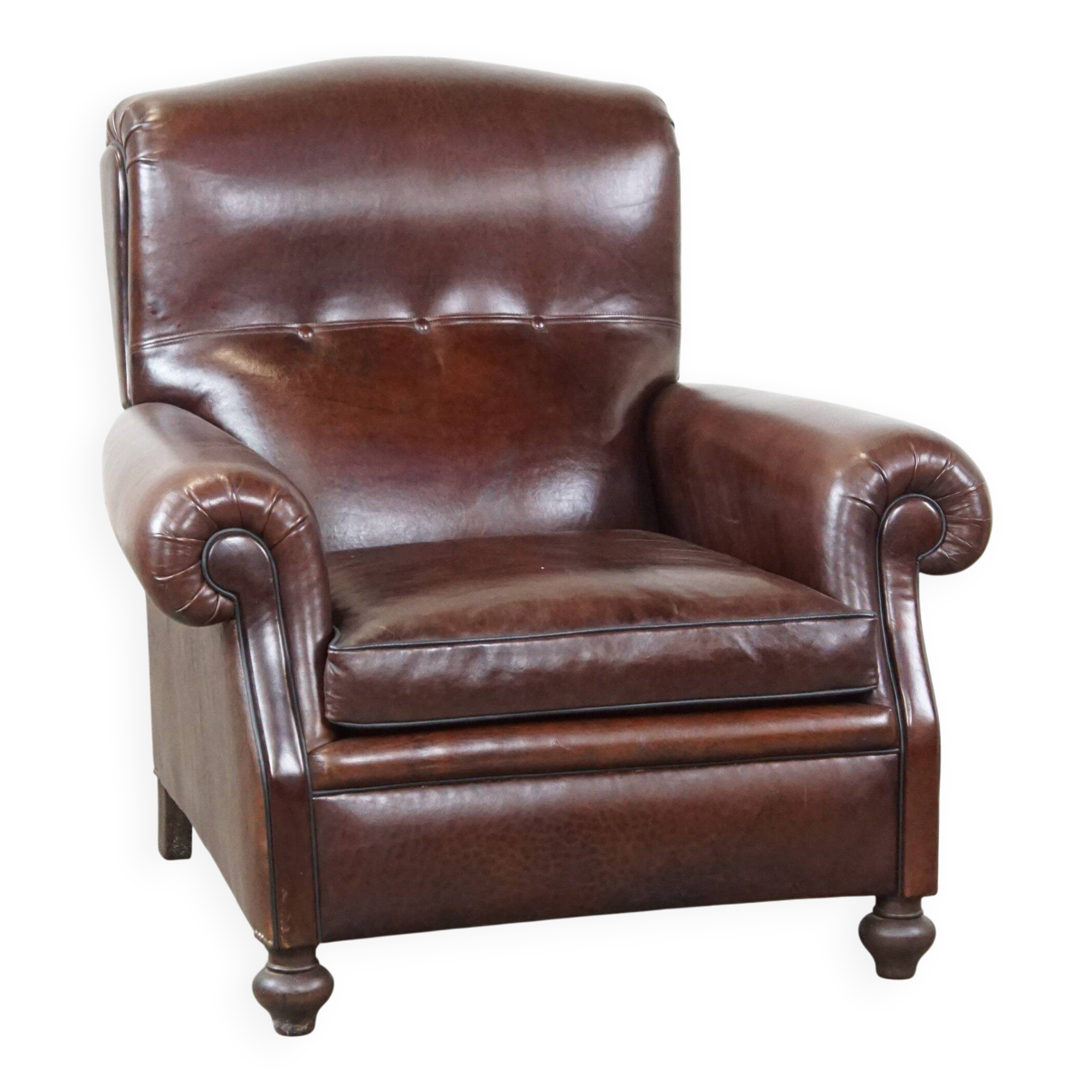 Comfortable and correct dark antique sheepskin English armchair in very good condition