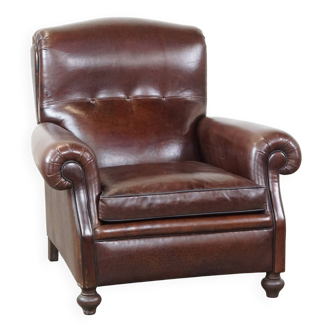 Comfortable and correct dark antique sheepskin English armchair in very good condition