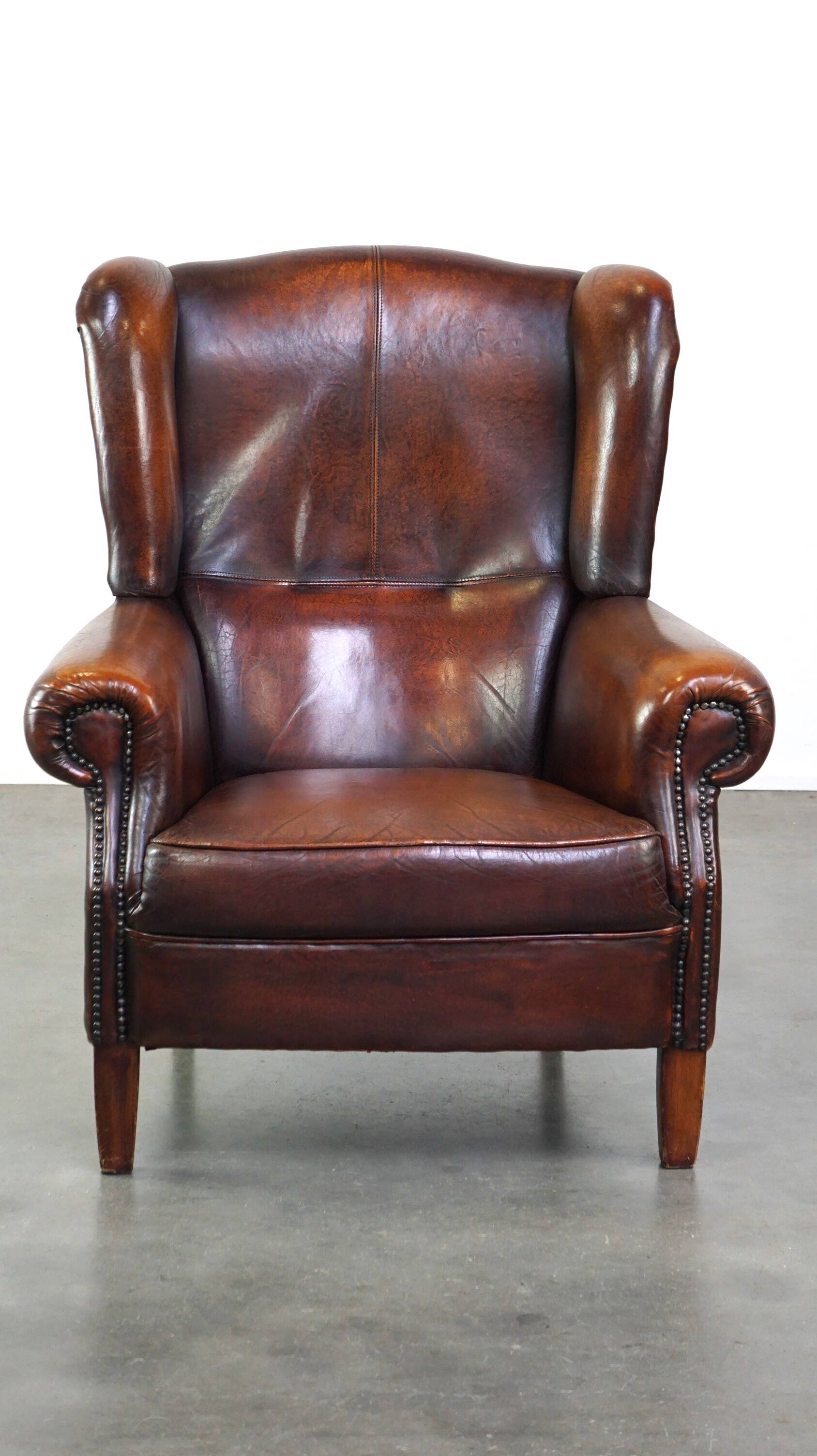 Luxurious sheepskin armchair with a fixed seat cushion and high seating comfort