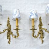 2 brass wall lights with toile de jouy lampshades