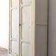Small antique wardrobe patinated in beige and yellow.