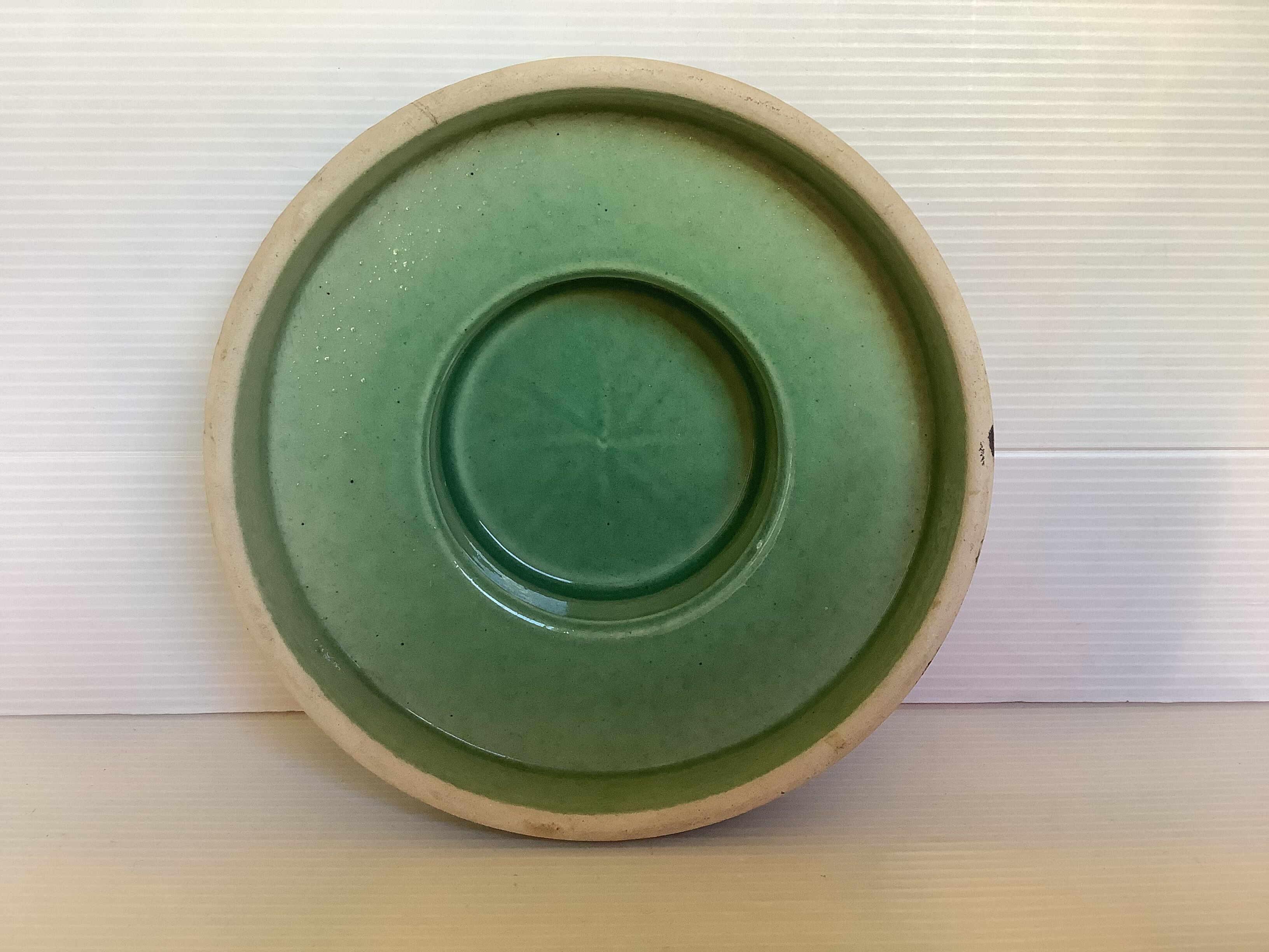 Green ceramic candle holder with a frieze