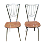 Pair of formica chairs with chrome metal backs in the shape of a lyre.
