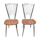 Pair of formica chairs with chrome metal backs in the shape of a lyre.