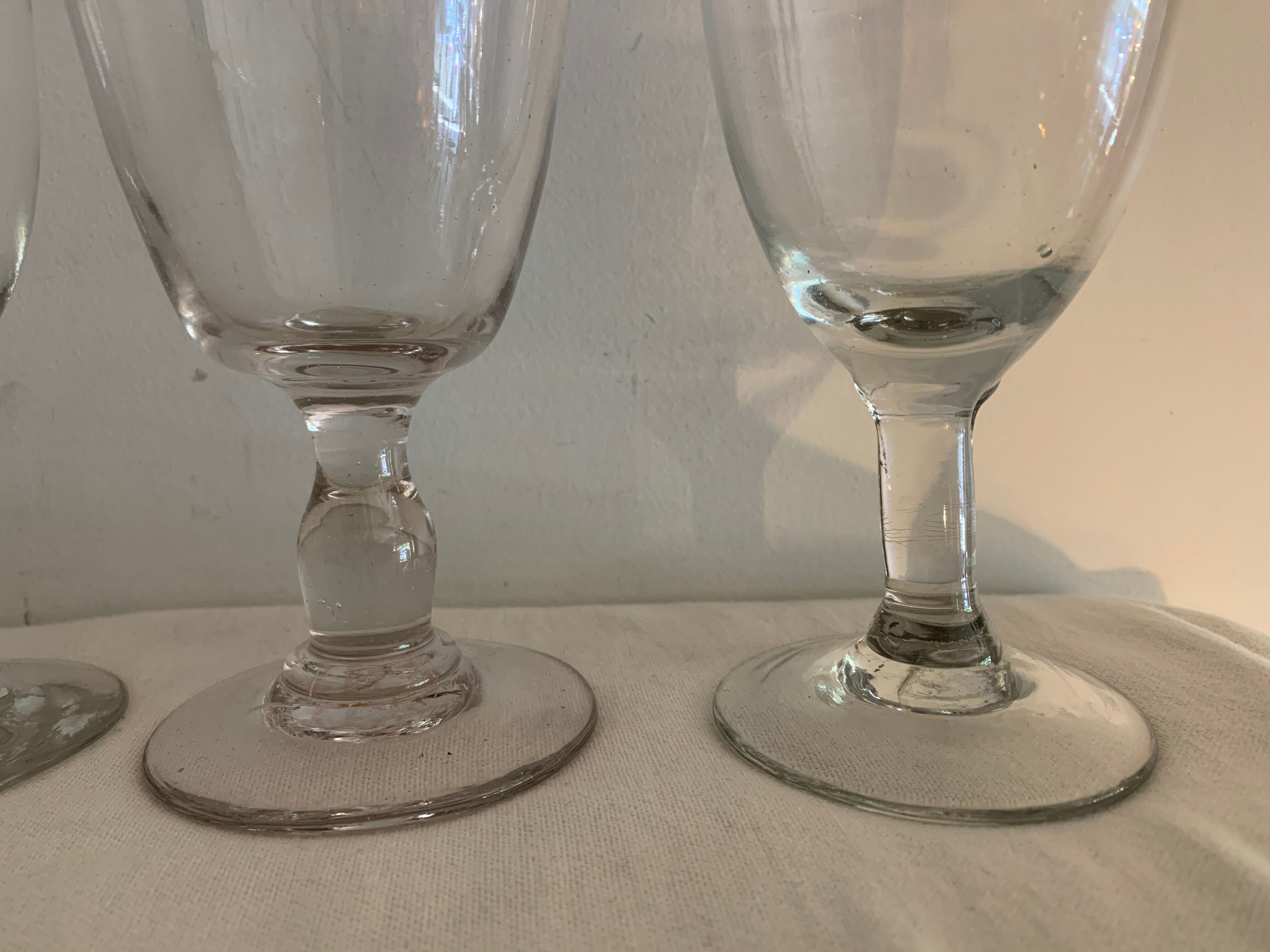 8 old blown and different foot wine glasses