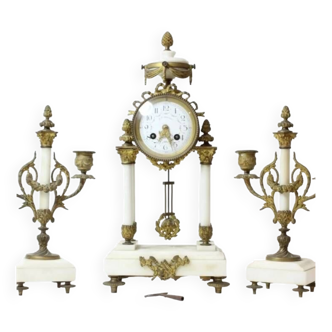 Clock and pair of Louis XVI style candelabras.