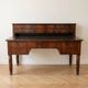 Antique wooden tiered desk with drawers and twisted legs.