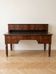 Antique wooden tiered desk with drawers and twisted legs.