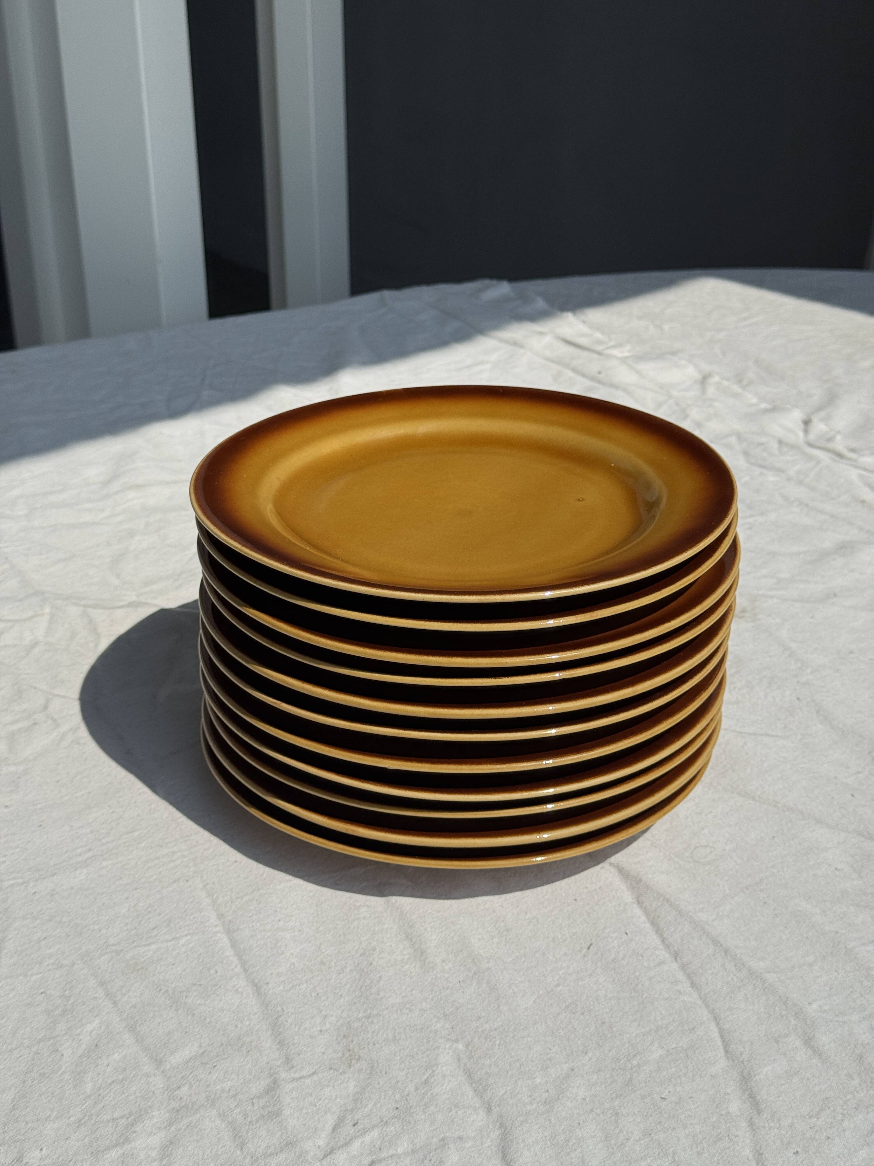 Set of 11 dark brown yellow stoneware plates D24
