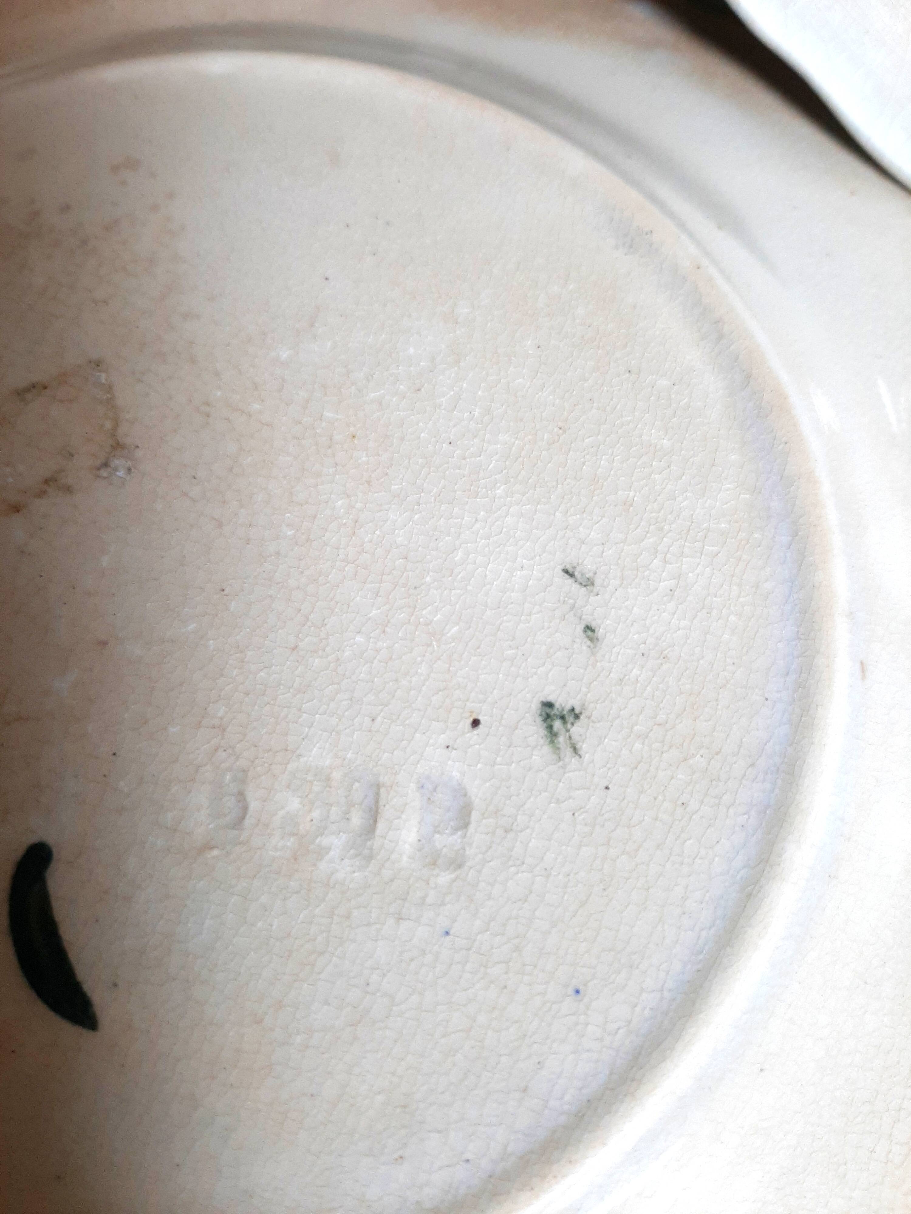 Antique earthenware plates with fruit decoration.