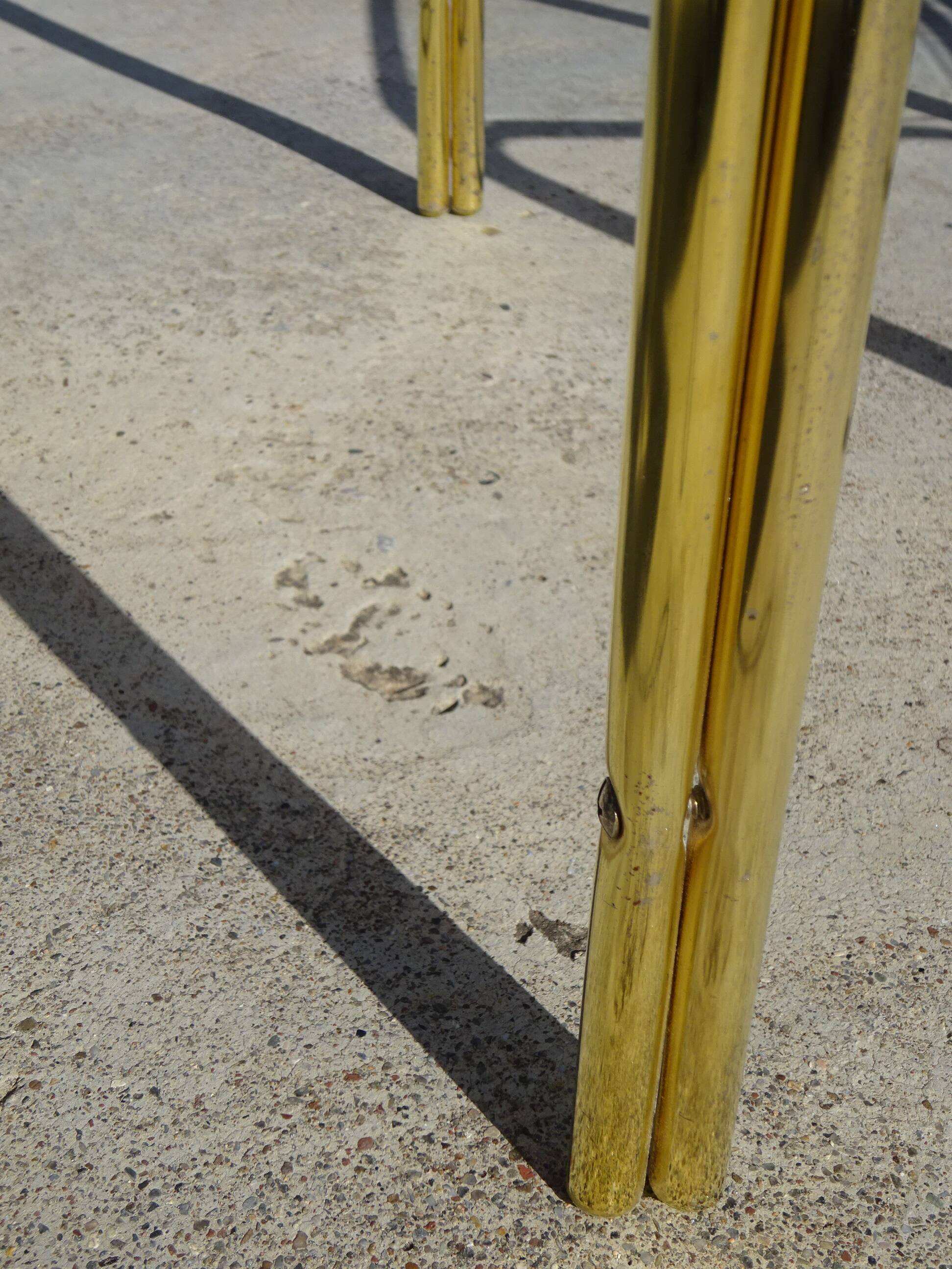 Nested tubular tables in gold metal.