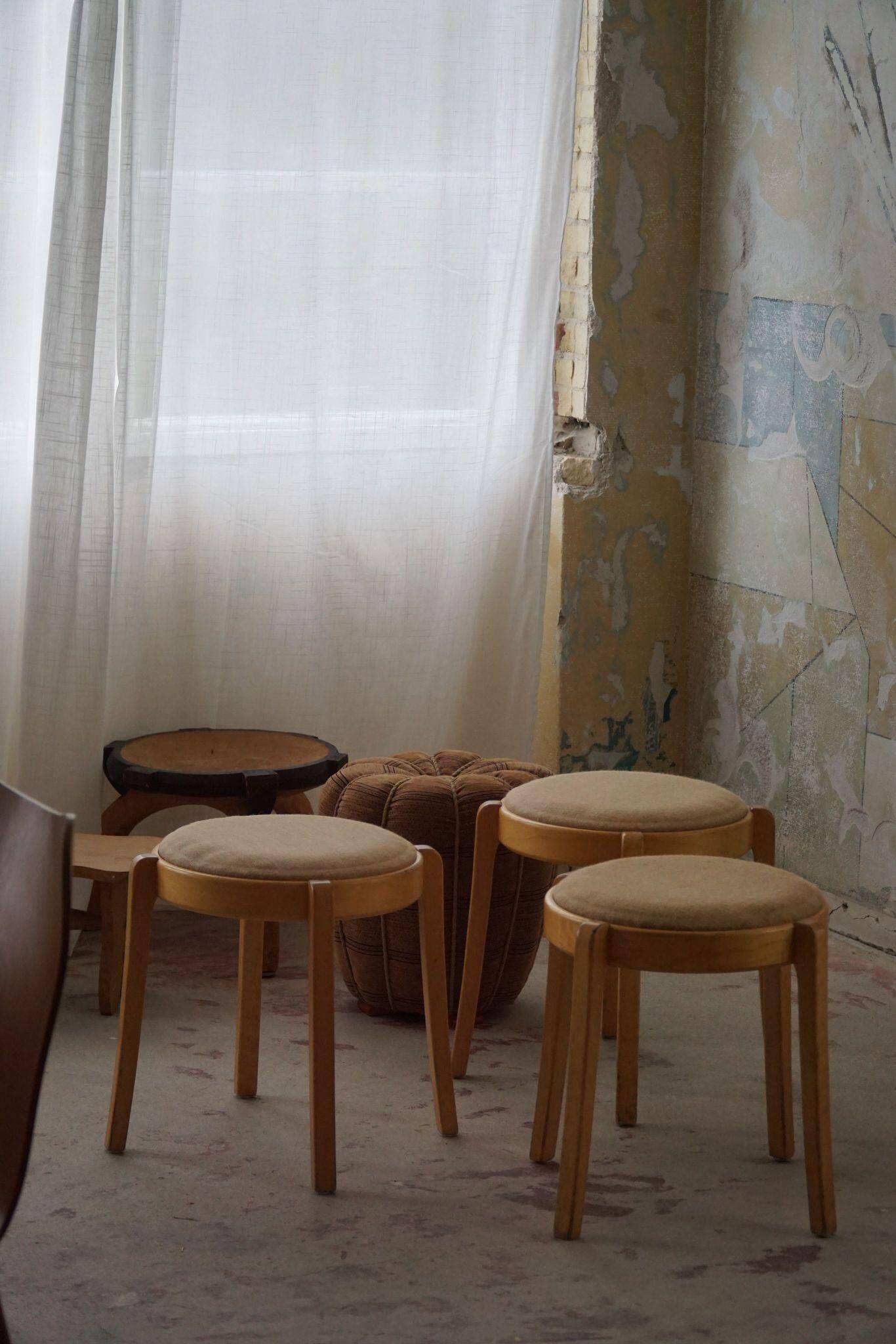 Modern Swedish, set of 14 stackable stools in birch and hessian fabric, 1980s.
