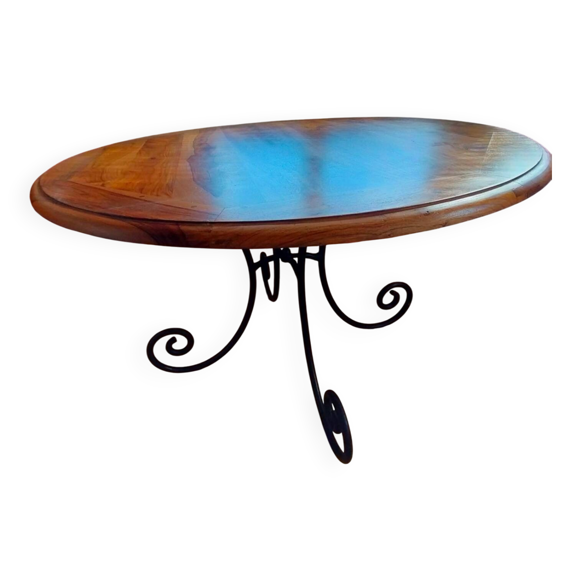 Round wooden table with wrought iron legs.