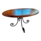 Round wooden table with wrought iron legs.